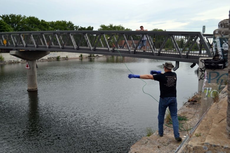 Man tossing rope into water