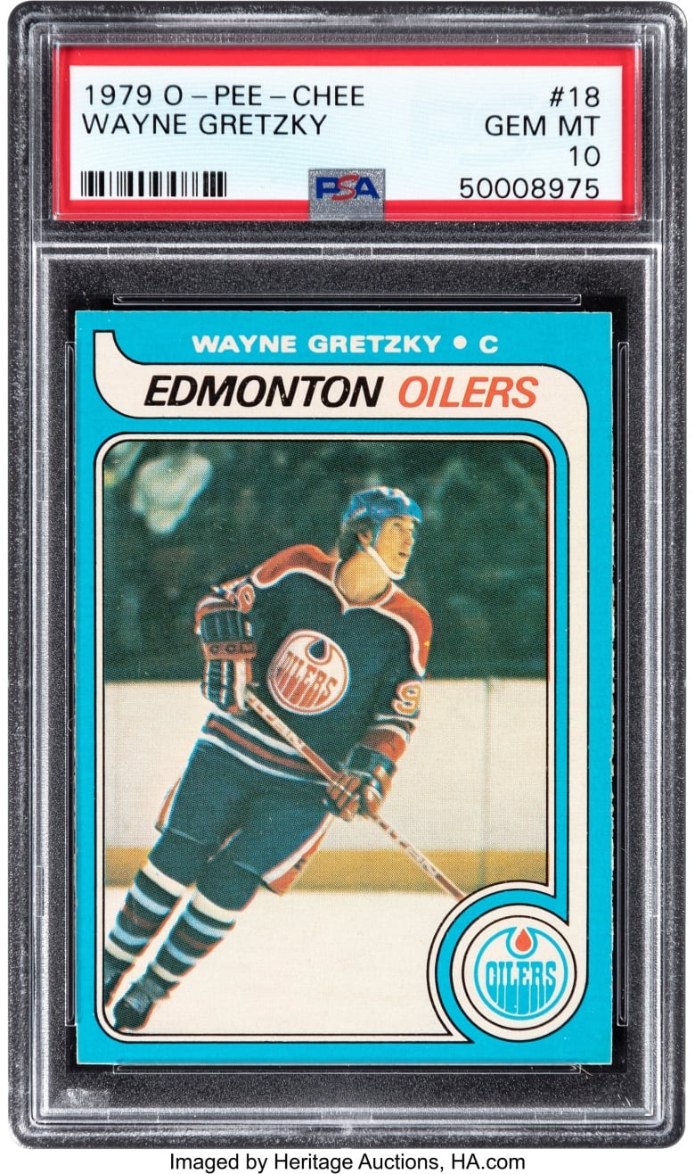 A hockey player in an Edmonton Oilers uniform skates on a slant in an image on a hockey card. The card says, "Wayne Gretzky, C, Edmonton Oilers." The card is in a clear sheath. Above the card a label reads, "1979 O-Pee-Chee, Wayne Gretzky, #18, GEM MT, 10, 50008975"