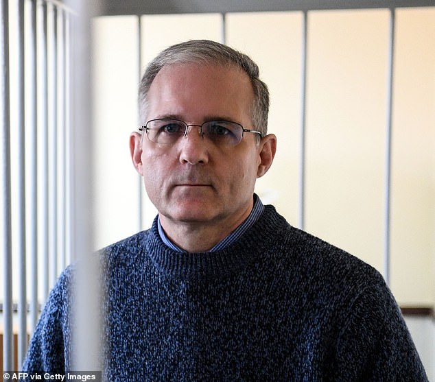 Paul Whelan, a former US Marine accused of spying and arrested in Russia, stands inside a defendants' cage during a hearing at a court in Moscow in 2019