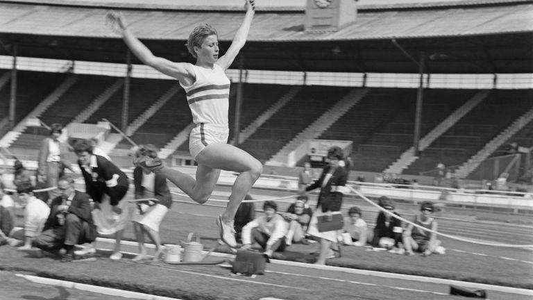 Rand competing in the long jump at White City