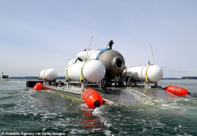 The Titan submersible is seen being towed out to sea on board its raft before it descended and imploded, killing all five on board