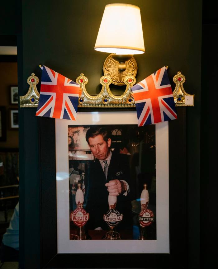 An image of the then Prince Charles pulling a pint