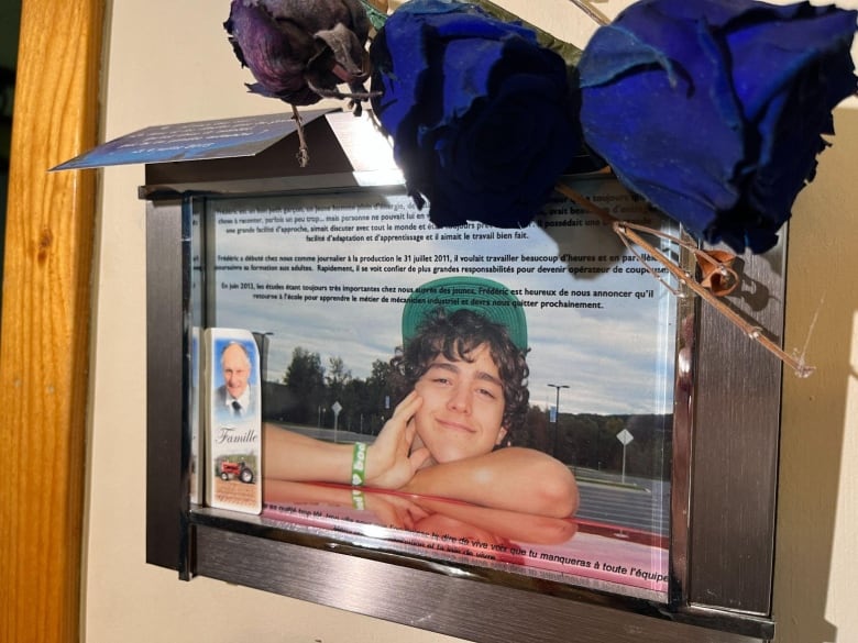 A framed photo of a young man. 