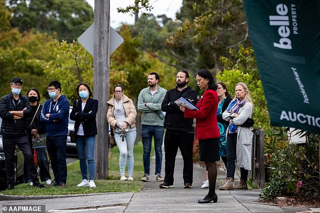 On Tuesday, the RBA moved to pause interest rates at an 11-year high of 4.1 per cent (pictured, prospective buyers attend an auction in Melbourne in April, 2022)