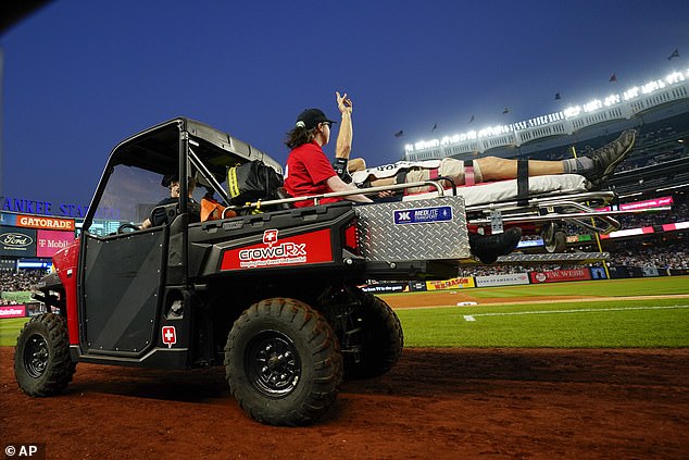 Pete Stendel, who works for YES Network, held up a peace sign as he was carted off the field