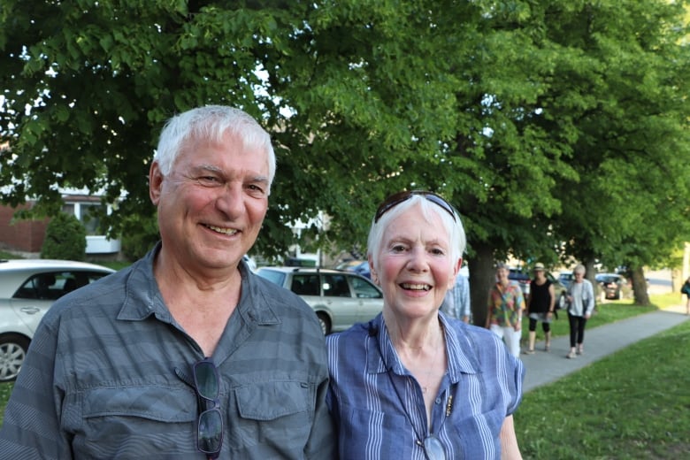 A man and a woman smile at the camera