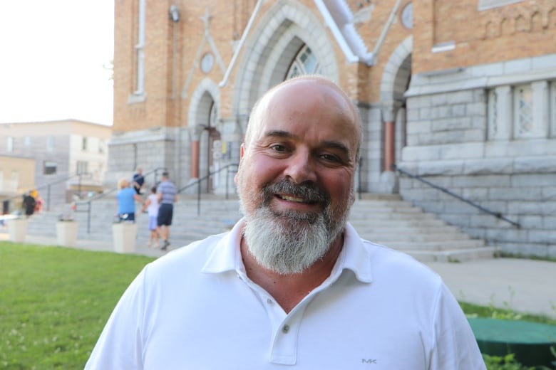 A man smiles at the camera 