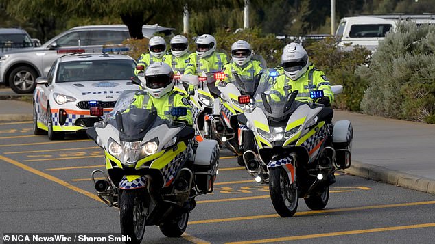 Police on motorbikes lead the sombre event at Perth's Optus Stadium