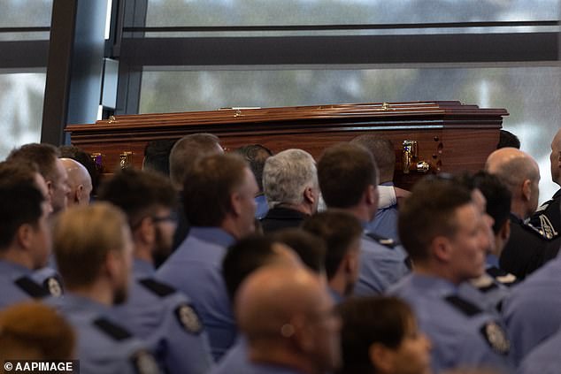 Some of the officers in attendance had come from as far away as NSW (pictured, the casket during the service)