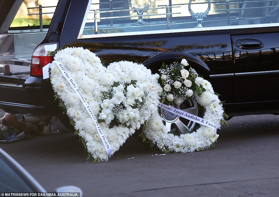 Flower reefs lent up against the hearse paid tribute to Mr Brikha - who was the youngest of nine children