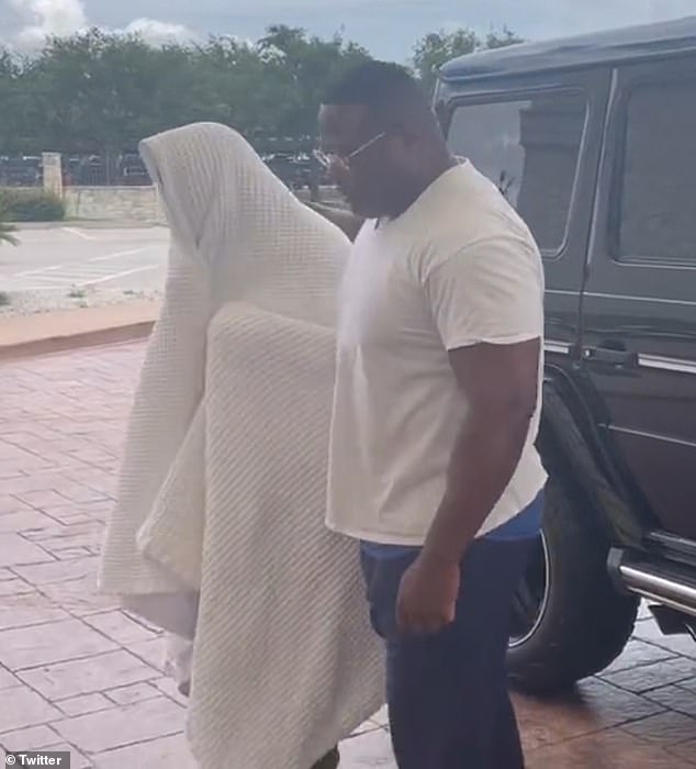 Farias was seen hiding his face under a blanket as he was escorted out of a Houston hotel by a community leader, Quanell X