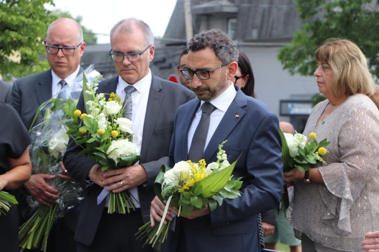 A man holds a bouquet of flowers 