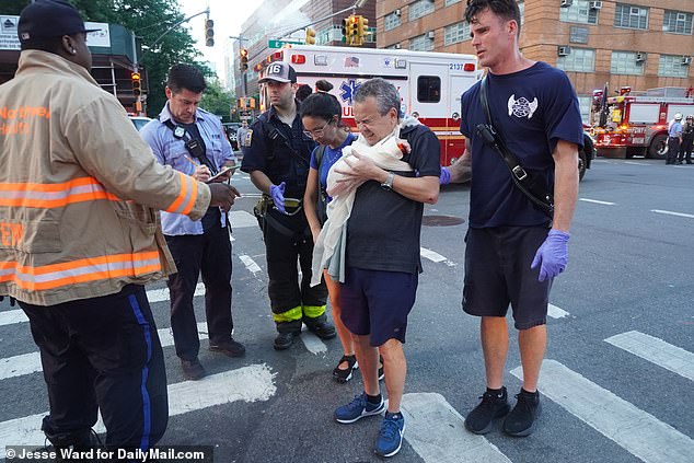 One man can be seen here being helped from the scene with his arm bandaged up, what appears to be blood is also visible on his hand, visibly in pain