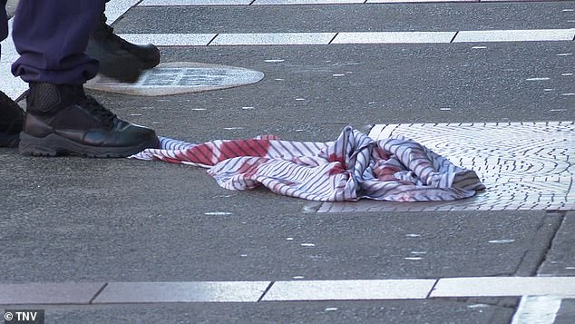 A blood-soaked shirt is seen discarded on the ground following the shooting in Marrickville