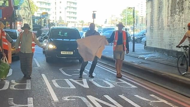 After grabbing the banners from their hands, the angry motorist then dumped them on the side of the road