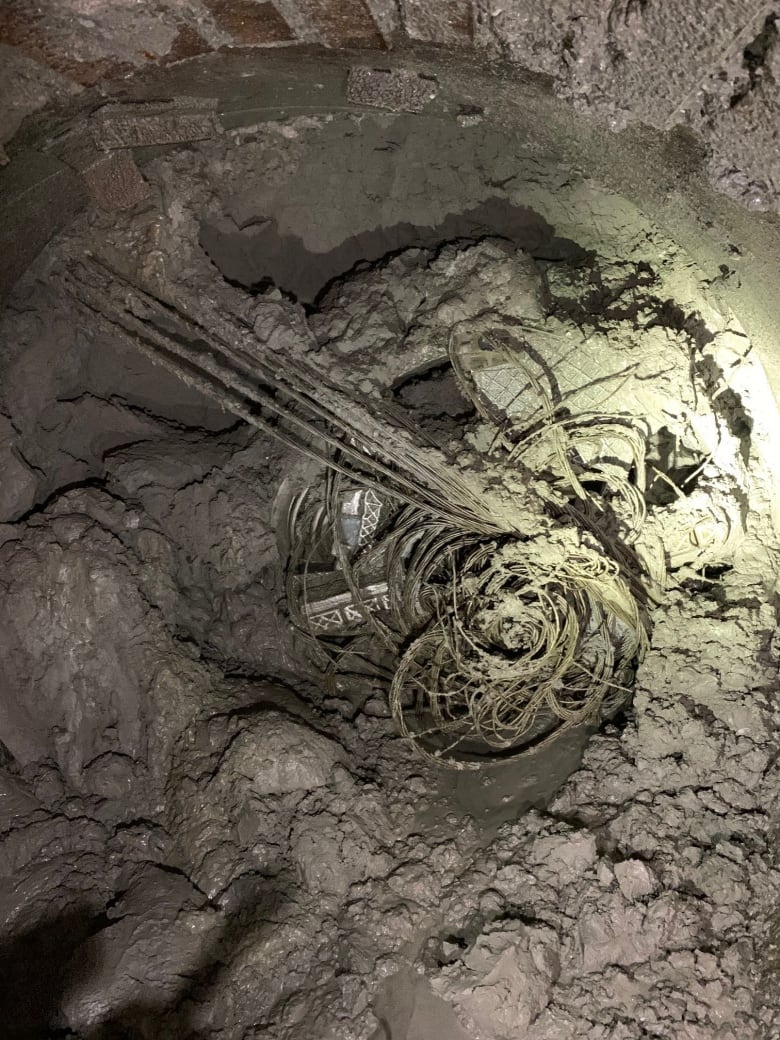 Steel tiebacks hang from the face of a micro-tunnelling boring machine which was being used by the city to create a new storm sewer on Old Mill Drive. This picture was taken underground shortly after contractors working on the project discovered that the vehicle was struck. The operation to remove it has been complicated by mud and water. 