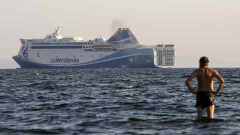 A man watches a ferry