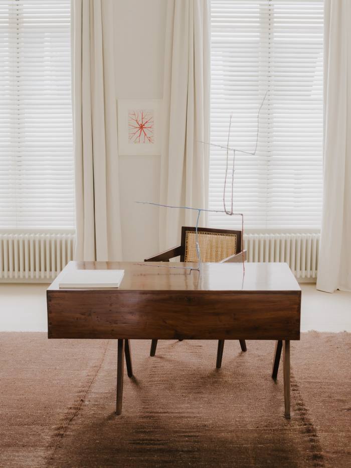 Untitled by Louise Bourgeois on the wall and Pierre Jeanneret chair and desk – with Split sculpture by Evan Holloway on it