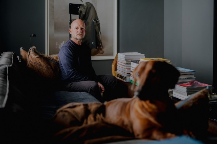 Van Duysen in front of a Wolfgang Tillmans photo print, with Pablo his dog in the foreground