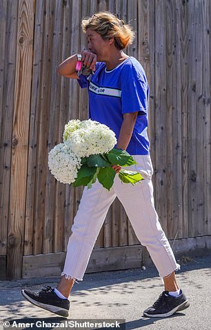 A woman places flowers at the scene of the tragedy in Wimbledon on Friday morning