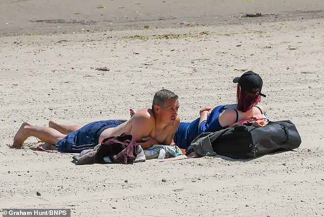 Sunbathers soaking up the rays yesterday at the seaside resort of Weymouth in Dorset