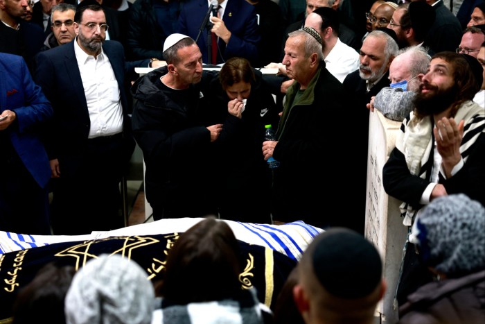 Mourners gather during the funeral of Eli Mizrahi and his wife, Natalie, who were killed in  a shooting attack in East Jerusalem in January