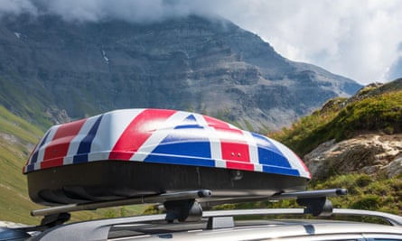 Roof baggage trunk in colours of UK flag on car in French Alps 