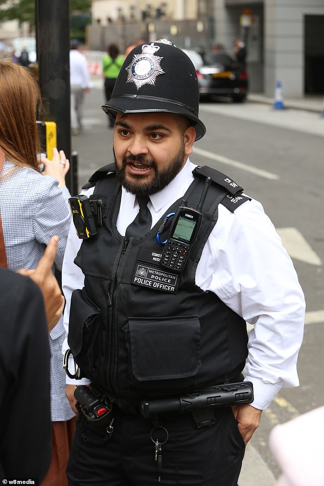 Officer were banned from wearing the black-and-white Union flag with a thin horizontal blue line if working at Pride celebrations in London (Pictured: Police at the London Pride March on July 1)