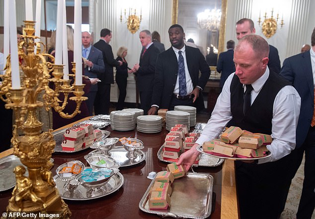 White House ushers plate chicken nuggets from McDonalds, some of the fast food the US president purchased for a ceremony honoring the 2018 College Football Playoff National Champion Clemson Tigers in 2019