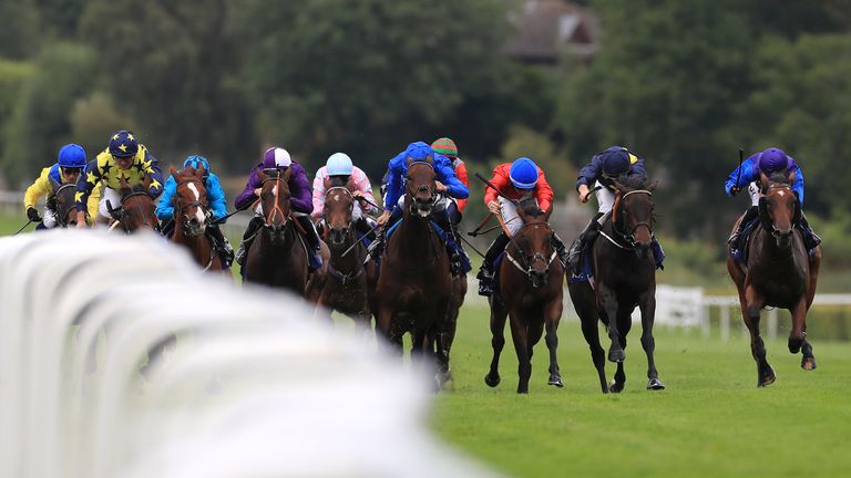 Mystic Pearl (blue and yellow) wins the Coral Distaff under Tom Marquand