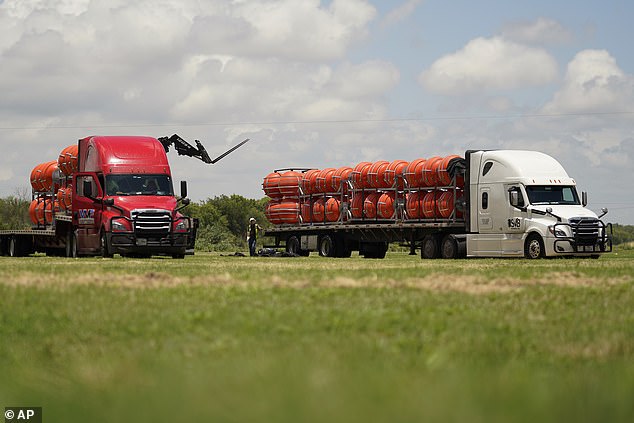 The buoys are seen being unloaded in Eagle Pass on Friday