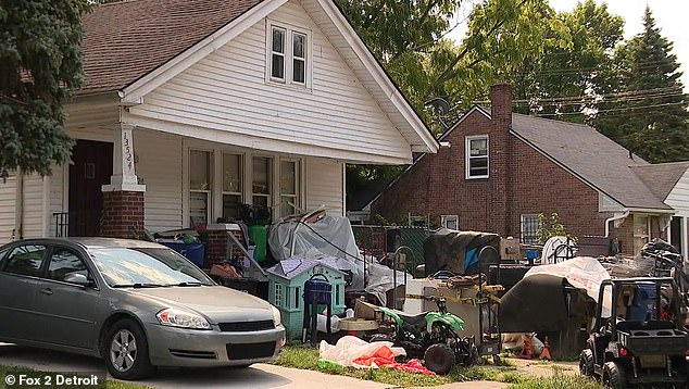 In this image, a quad bike and an all terrain vehicle sit amongst the rubbish which also includes a dolls house