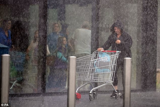 Britain is braced for even more wet weather today, with thunderstorms set to strike in north west England and the midlands later this afternoon (Pictured: heavy rain in Speke , Liverpool, yesterday)