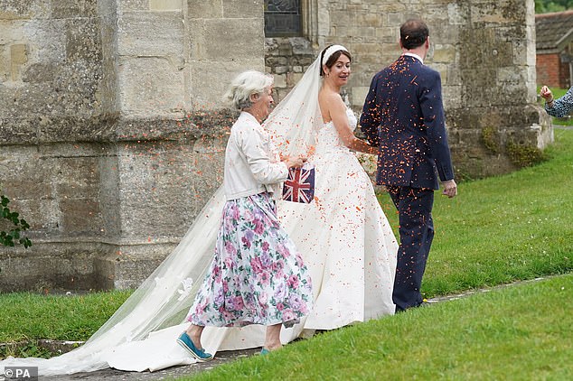 Just Stop Oil retweeted a video of the incident, posting: 'You look good in orange George Osborne — congratulations to the newlyweds.'