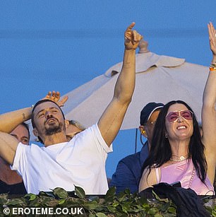 Party! The couple excitedly threw their hands in the air during one song