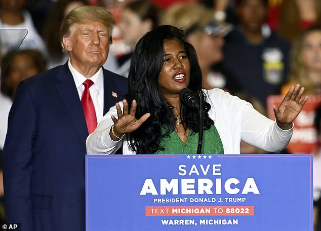 Former President Donald Trump, left, listens as Michigan Republican Secretary of State was seen during a rally in October 2022 (file photo)