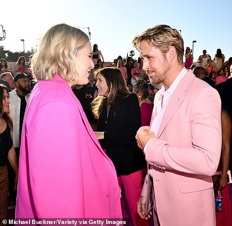 At the helm! Ryan took a moment in the chaos to catch up with director Greta Gerwig (L)