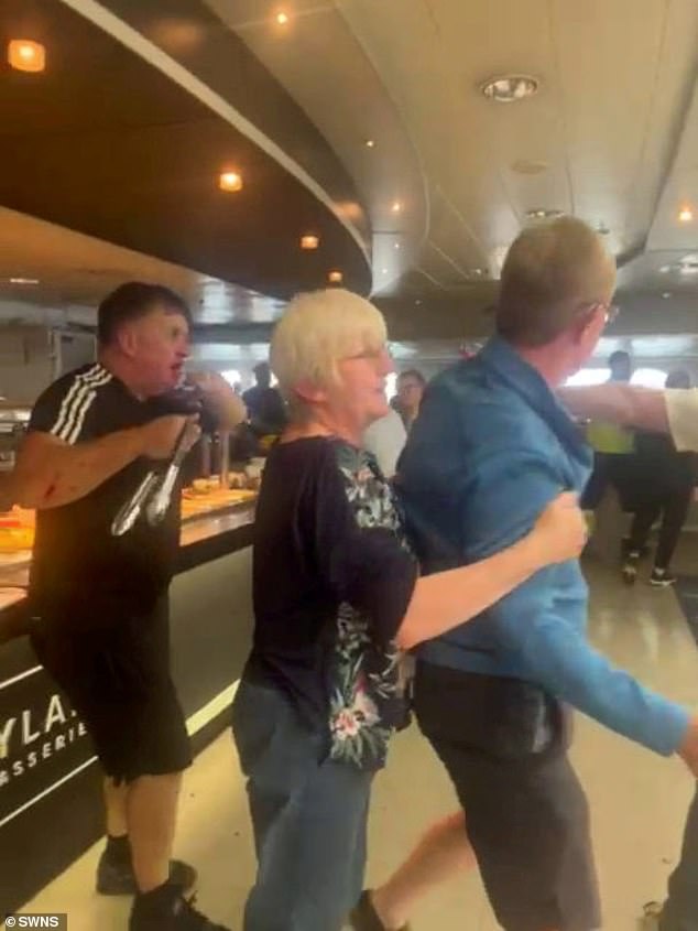 Although the footage is unclear, the video appears to show a man in an Adidas top using salad tongs to defend himself as he is being mobbed before the the fight was eventually separated on the Irish Ferries service