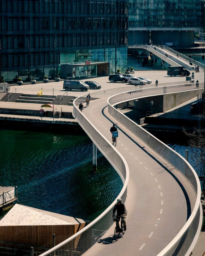 Cyclists crossing Copenhagen’s S-shaped Snake Bridge