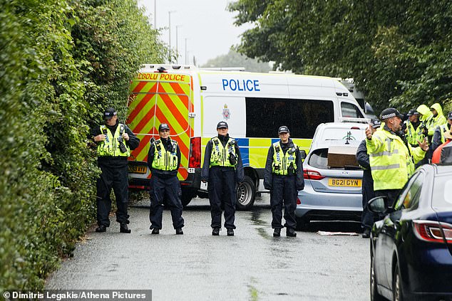 Police officers lined up outside the Stradey Park Hotel in Llanelli, Wales