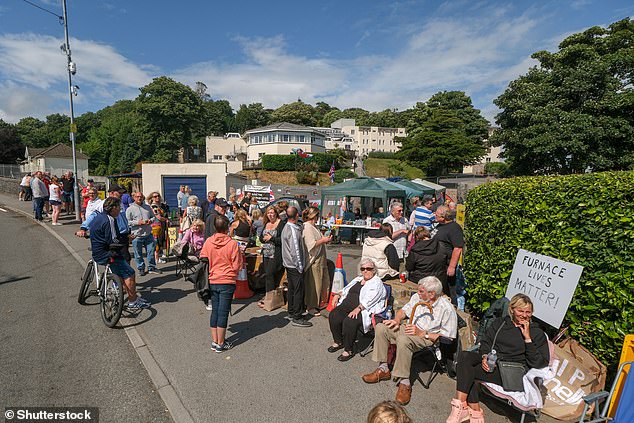 Local campaigners have surrounded the hotel in opposition to the Home Office plans