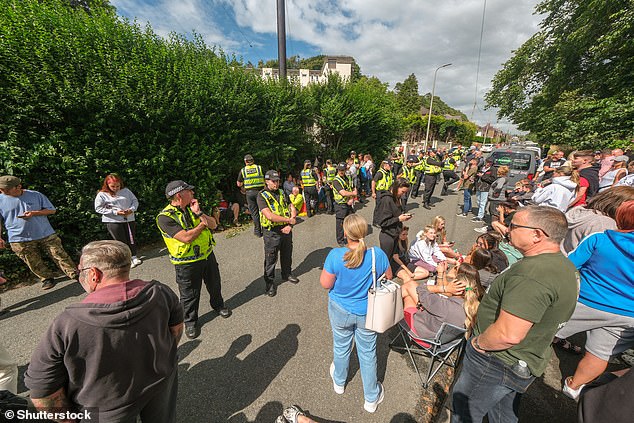 Police arrested two people accused of preventing the removal of a vehicle that was blocking the entrance to the four-star hotel