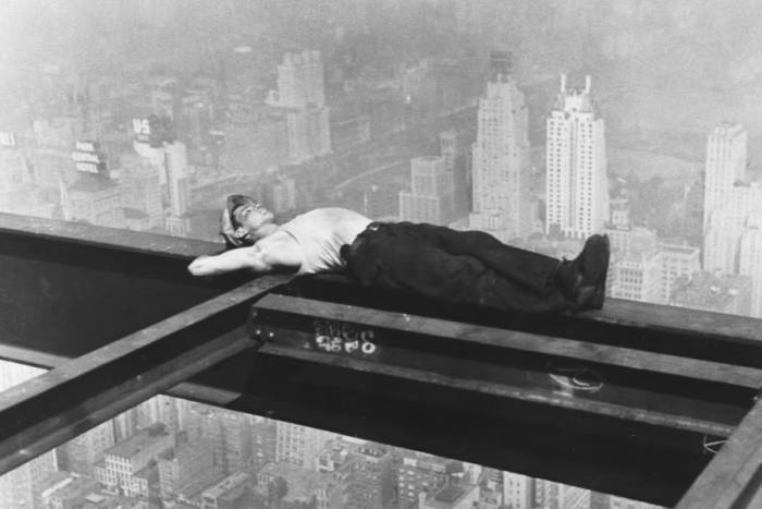 A workman takes a nap on a girder during the building of Radio City in New York in 1933