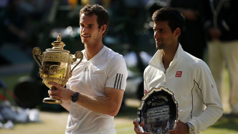 Andy Murray (L) displays the Wimbledon men&#39;s singles trophy after defeating Novak Djokovic in 2013 (PA Images)