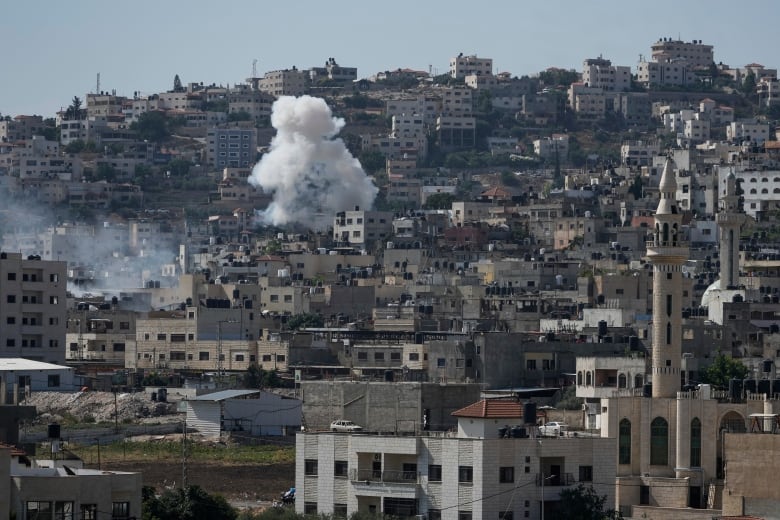 Smoke rises from a building.