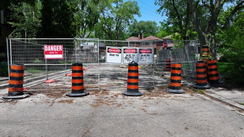 Pilons and gating block off a portion of Old Mill Drive where work continues to rescue multi-million dollar boring machine trapped below the surface.