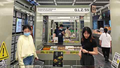 Customers shop at a warehouse in Shanghai, China