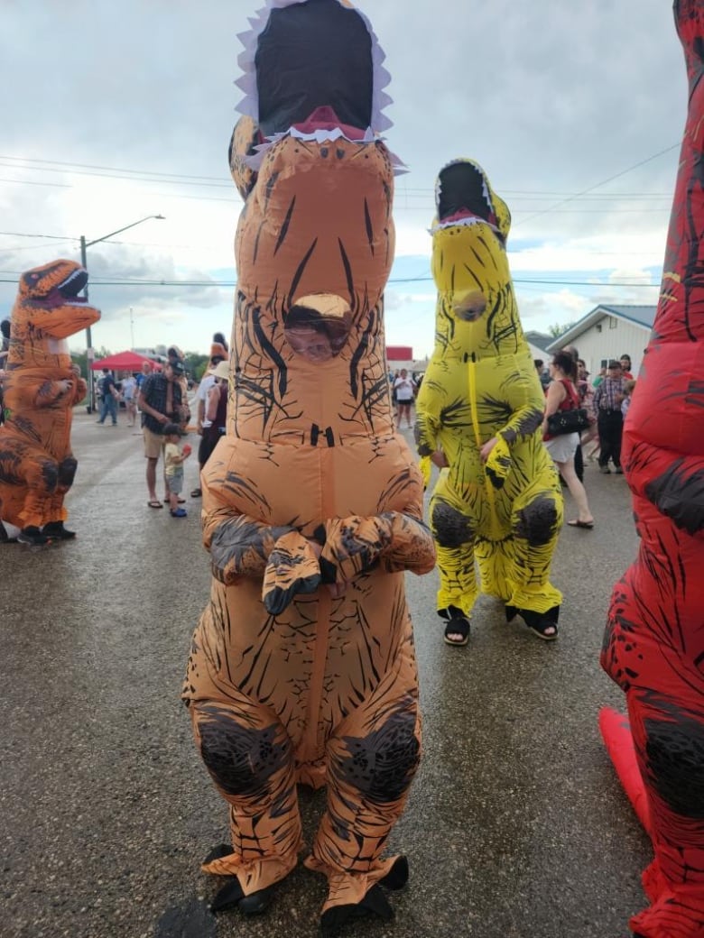 People in dinosaur costumes roam the streets in dundurn.