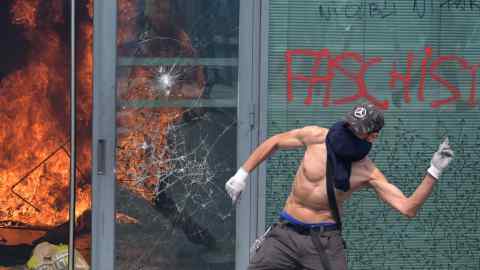 A protester throws an object at police in Nanterre. The latest protests demonstrate that France’s impoverished, ethnically-mixed neighbourhoods remain a powder keg