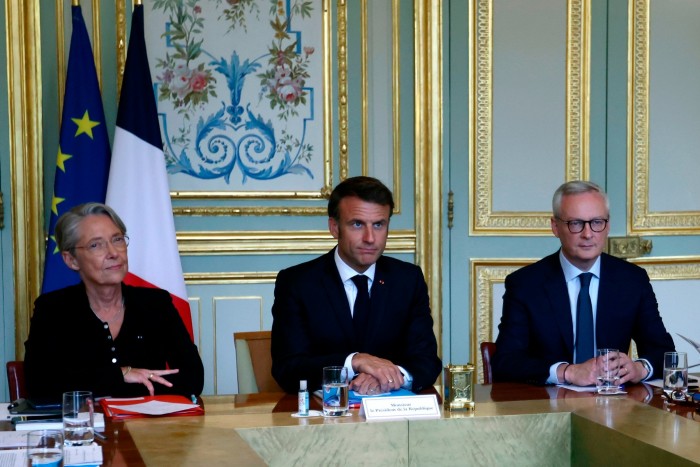 French president Emmanuel Macron, centre, with prime minister Élisabeth Borne, left, and economy minister Bruno Le Maire